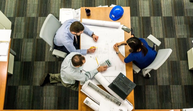 3 people working at a table