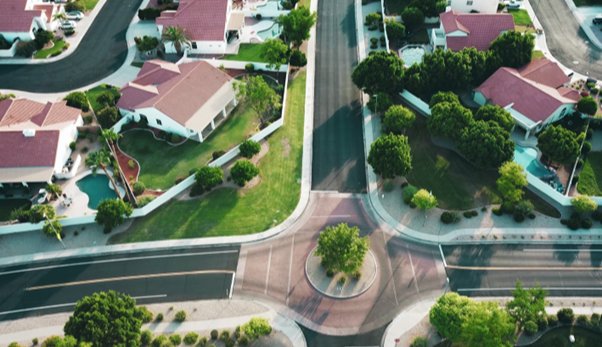 Overhead view of neighborhood with streets and houses and a roundabout